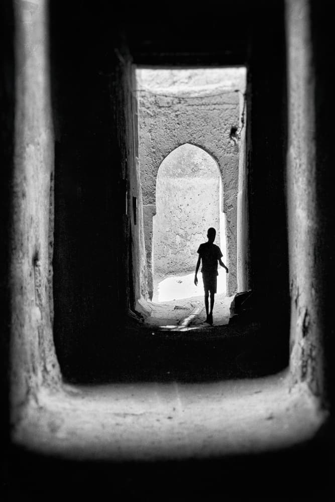 Child in Archway Light by txules — canvas wall art