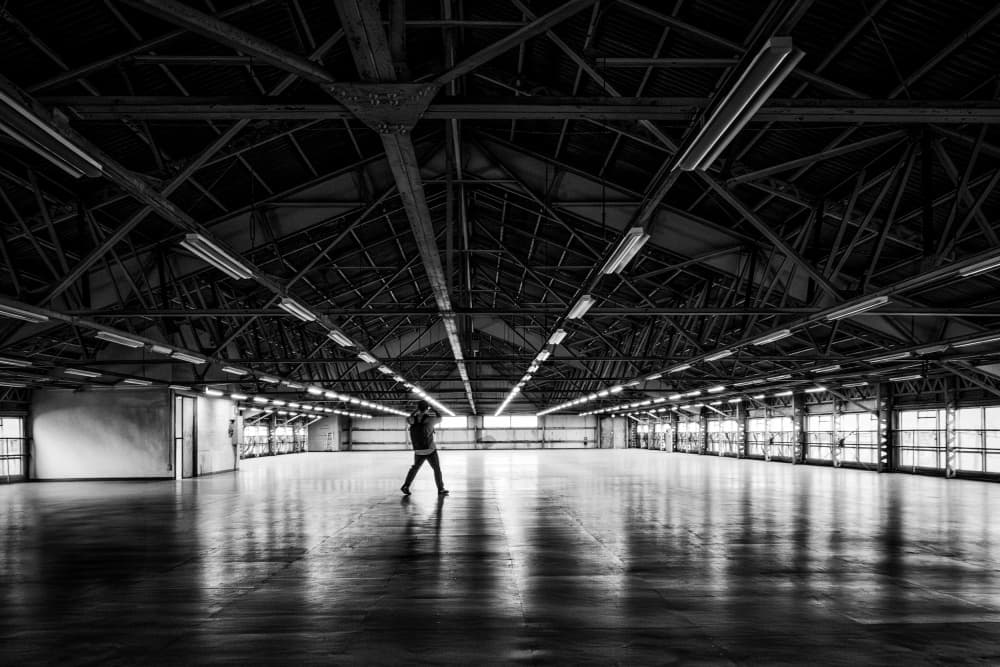 Lone Figure in Warehouse by Haruyo Sakamoto — canvas wall art