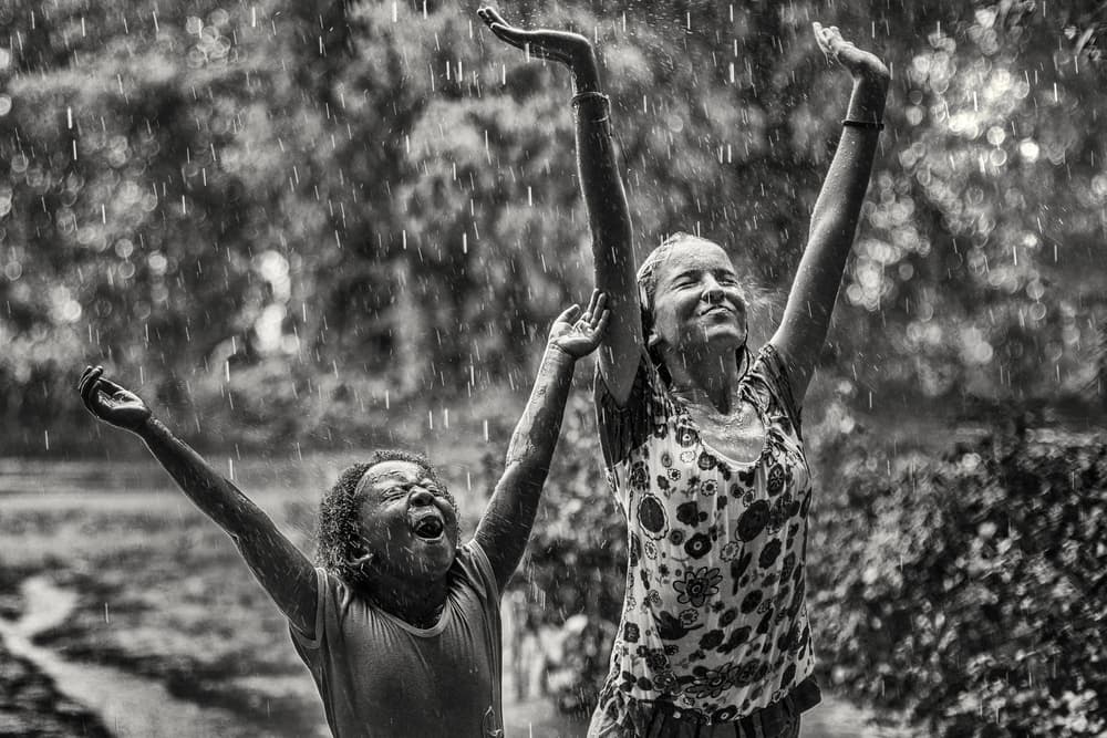 Joyful Children in Rain by Gloria Salgado Gispert — canvas wall art