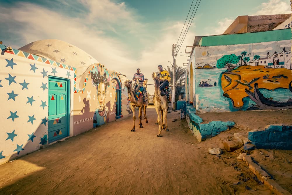 Camels in Colorful Village by Bassant Meligy — canvas wall art