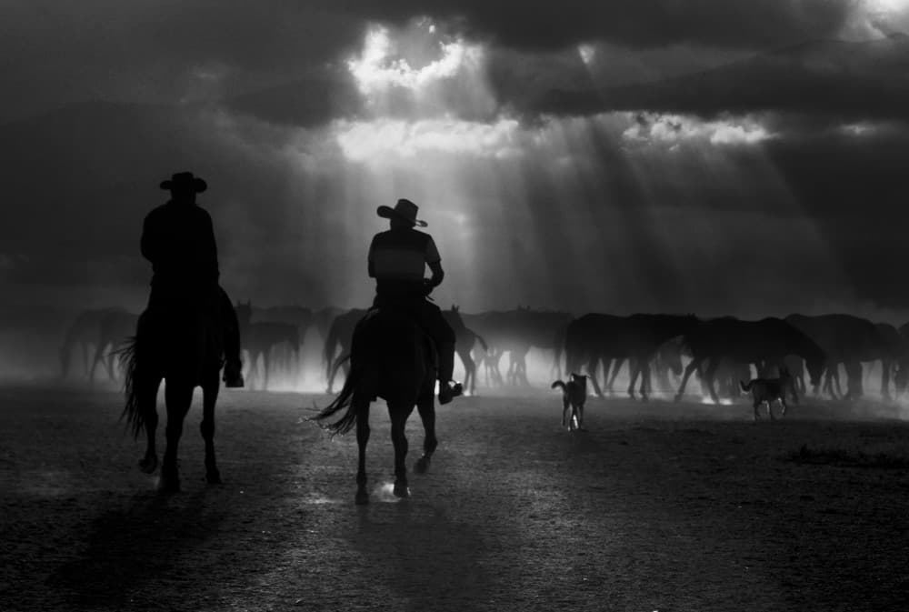 Cowboys Under Dramatic Sky by Emine Basa — canvas wall art
