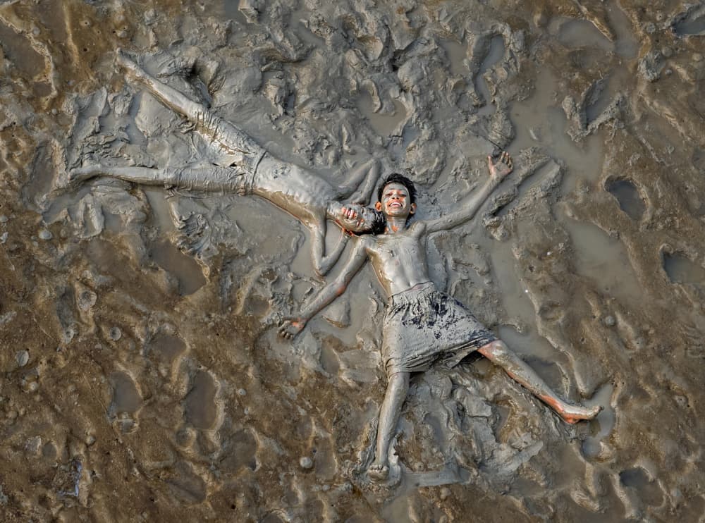 Muddy Kids Playing by Nilendu Banerjee — canvas wall art
