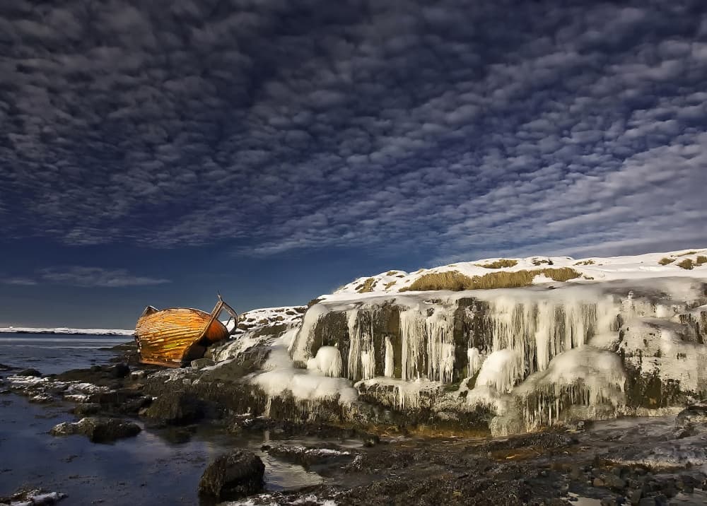 Frozen Shoreline Abandoned Boat by Þorsteinn H. Ingibergsson — canvas wall art