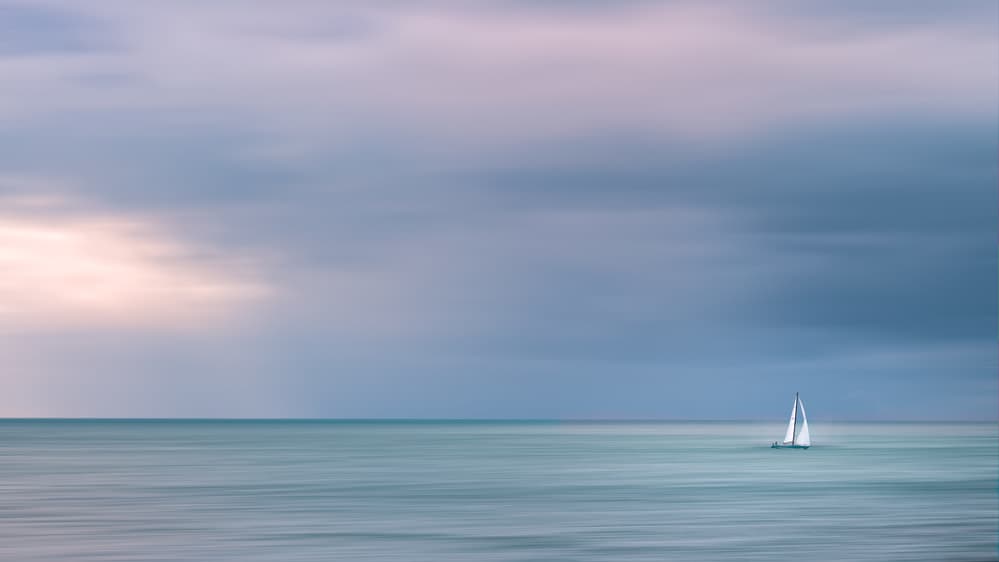 Lone Sailboat on Tranquil Sea by Cristiano Giani — canvas wall art