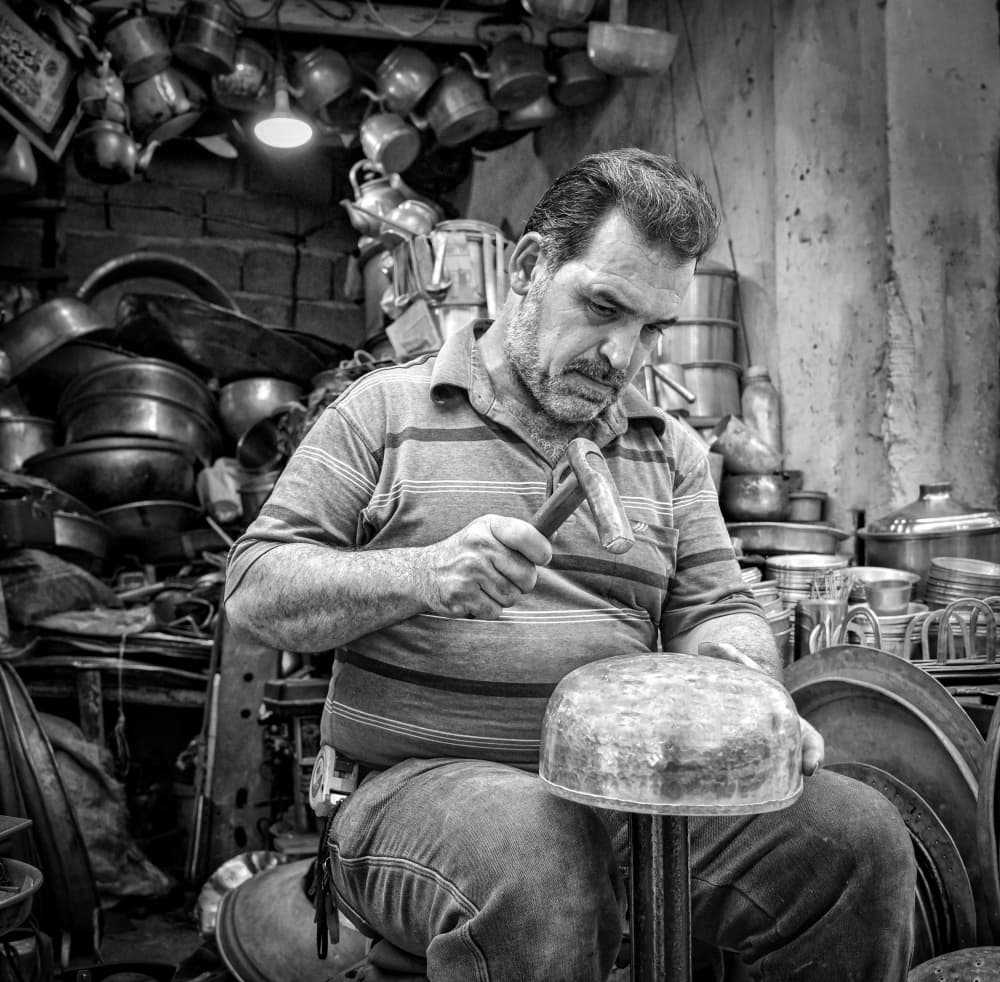 Artisan Hammering Metal by Bashar Alsofey — canvas wall art