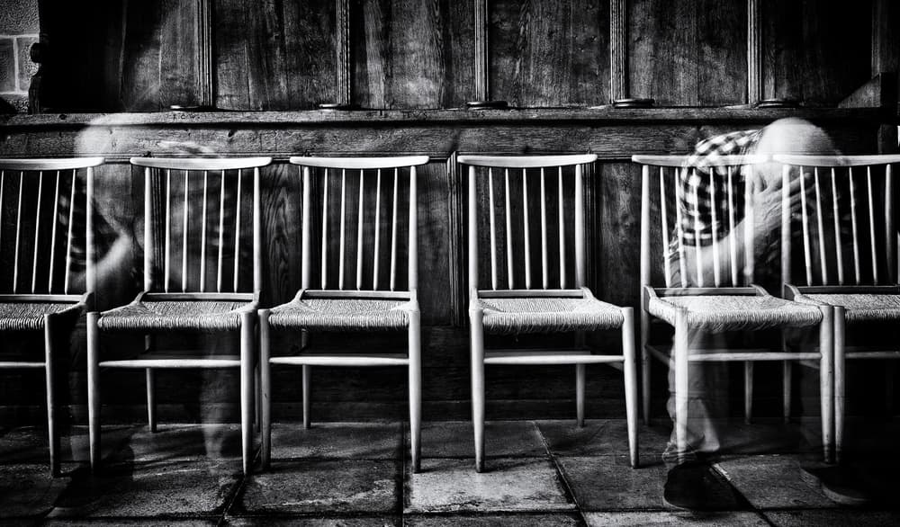 Blurred Figures Empty Chairs by Jürgen Hartlieb — canvas wall art