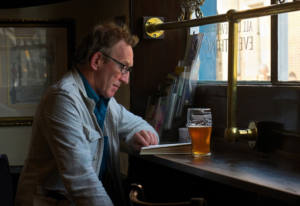Man Reading In Pub by Emanuel Papamanolis — canvas wall art