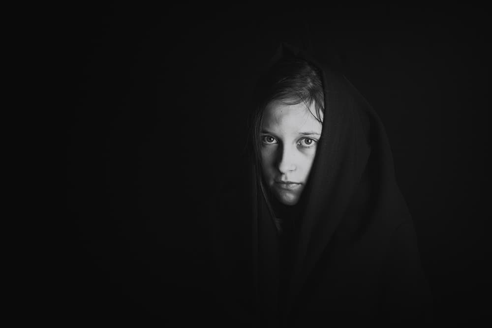 Pensive Girl Dark Hood by Mirjam Delrue — canvas wall art