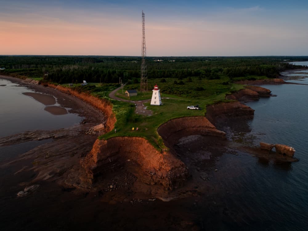 Red Cliffs Lighthouse Sunset by Ambar Saha — canvas wall art