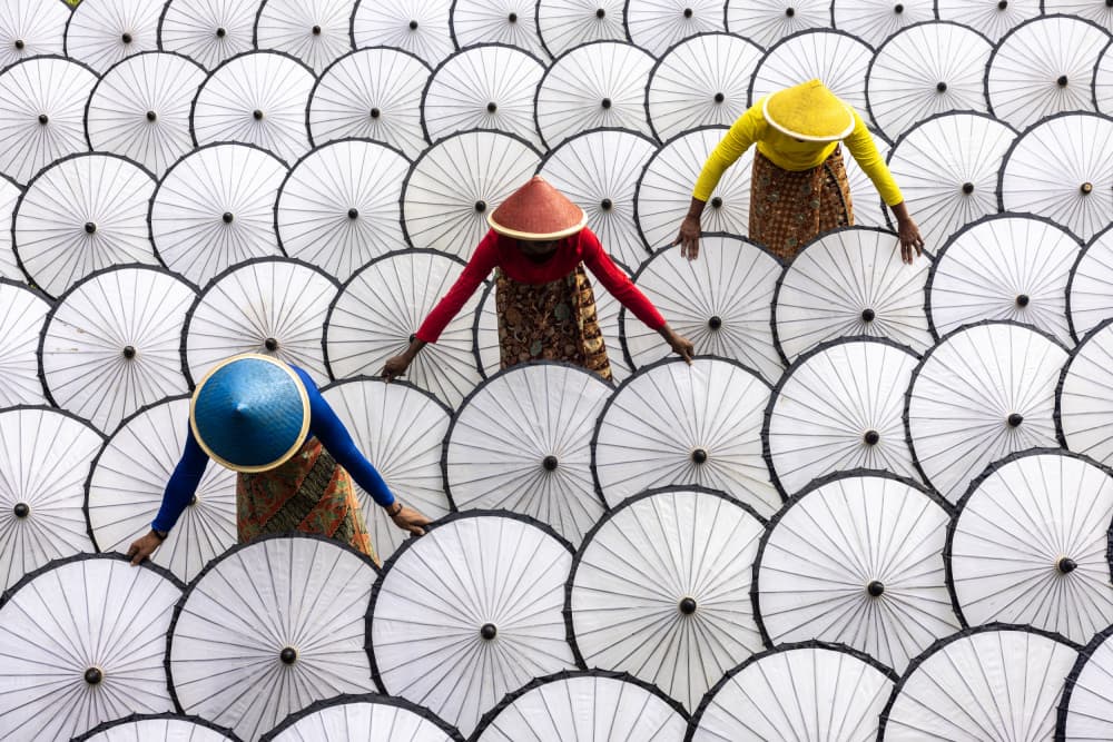Women Drying Umbrellas by Sally Widjaja — canvas wall art