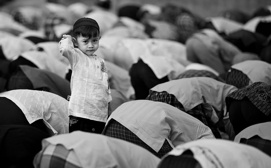Curious Boy In Prayer by Sebastian Kisworo — canvas wall art