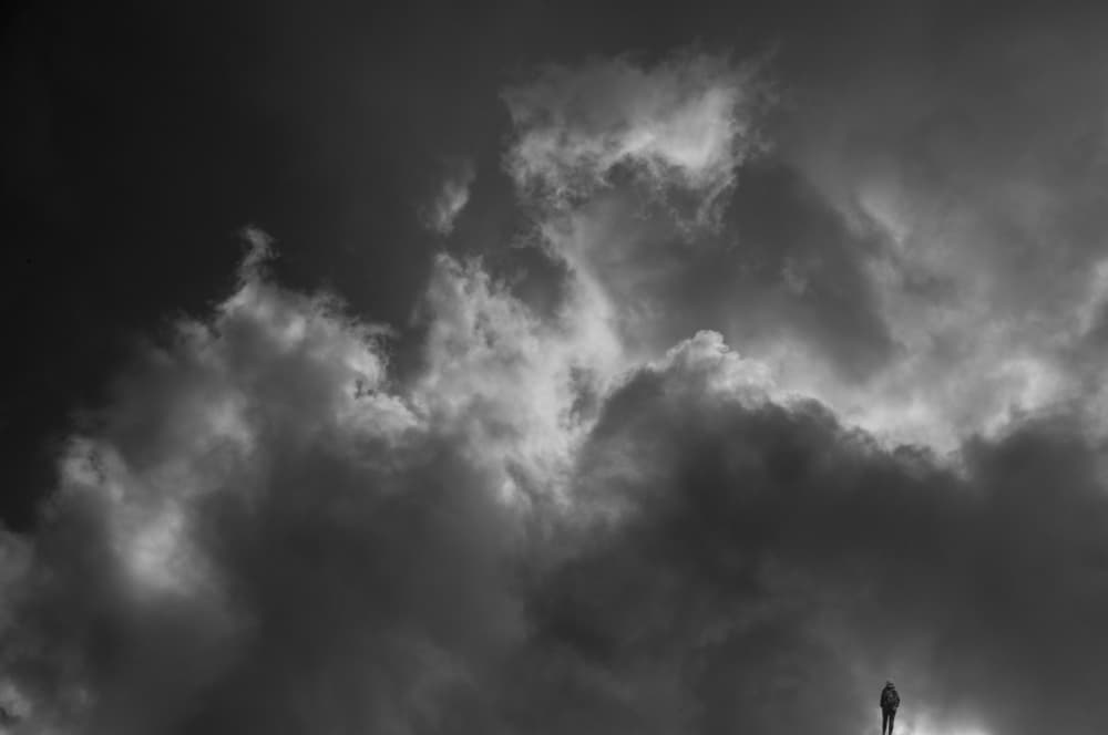 Lone Figure Dark Clouds by Dave Quince — canvas wall art