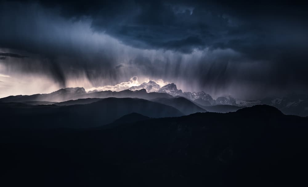 Light Through Stormy Mountains by Ales Krivec — canvas wall art