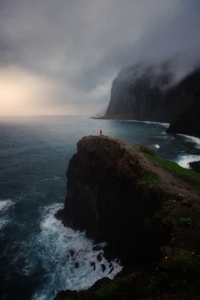 Lone Figure Coastal Cliffs by Junbo Liang — canvas wall art