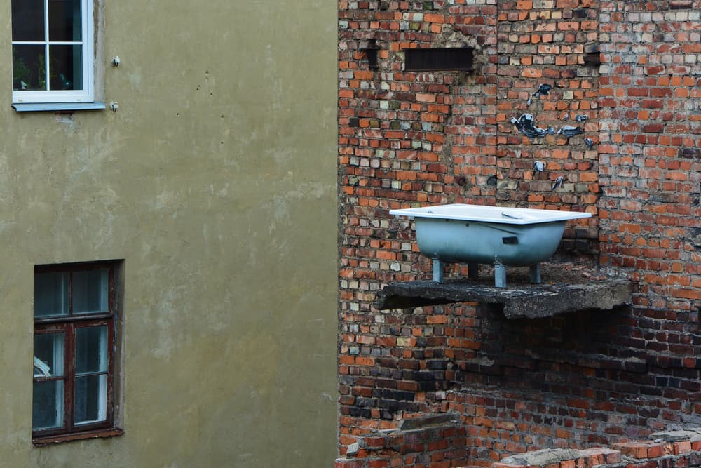 Bathtub On Brick Wall by Giedre Trakimaviciene — canvas wall art
