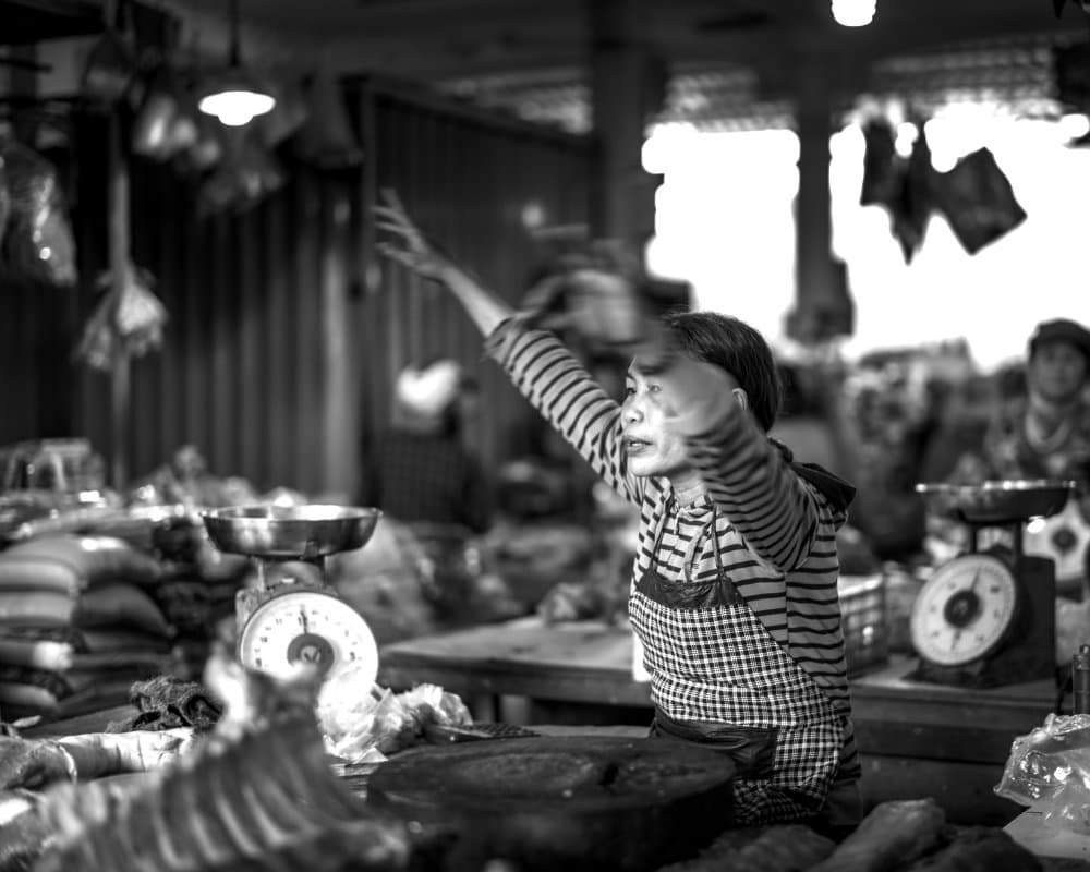 Market Vendor Reaching by Luis Borges Alves — canvas wall art