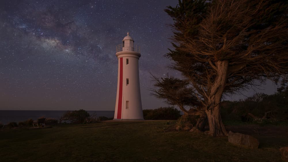 Lighthouse Under Stars by Emanuel Papamanolis — canvas wall art