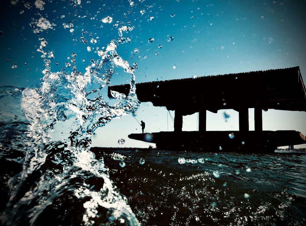 Ocean Splash Fishing Silhouette by Mirela Momanu — canvas wall art