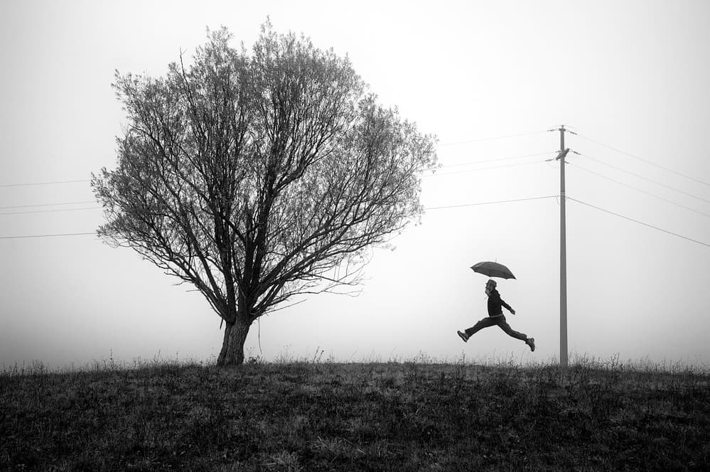 Umbrella Man's Misty Flight by Carlo Ferrara — canvas wall art