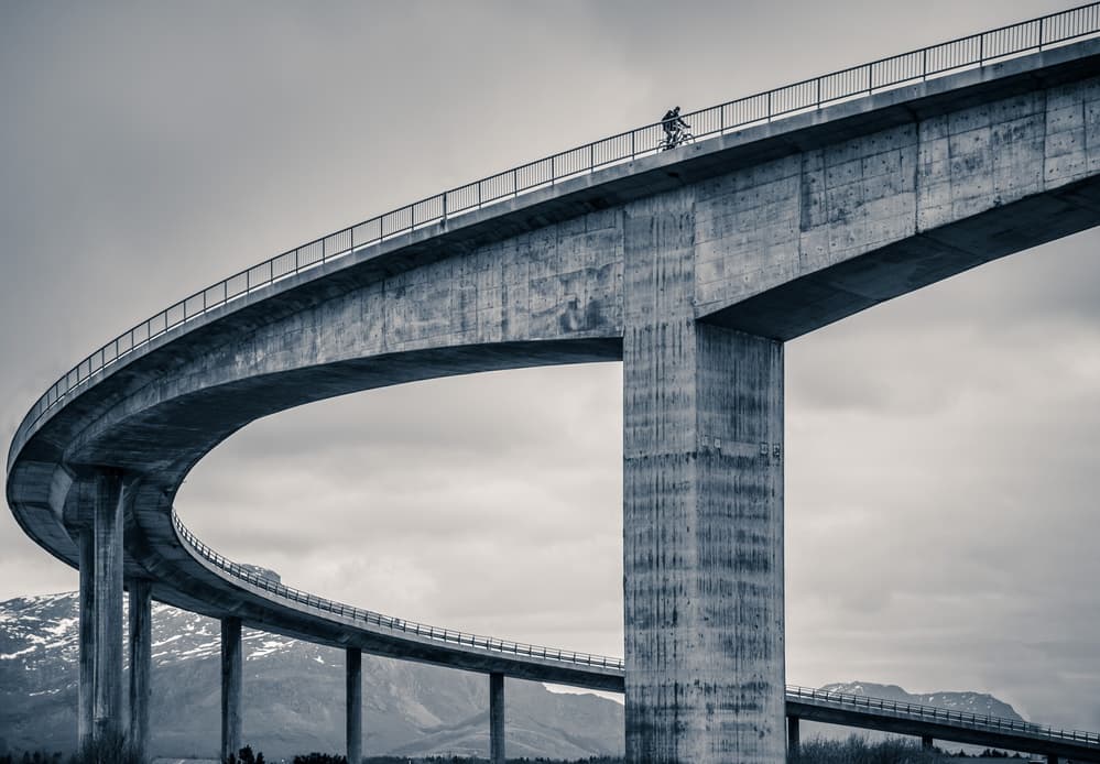 Cyclist on a Curved Bridge by Mette Caroline Strøksnes — canvas wall art