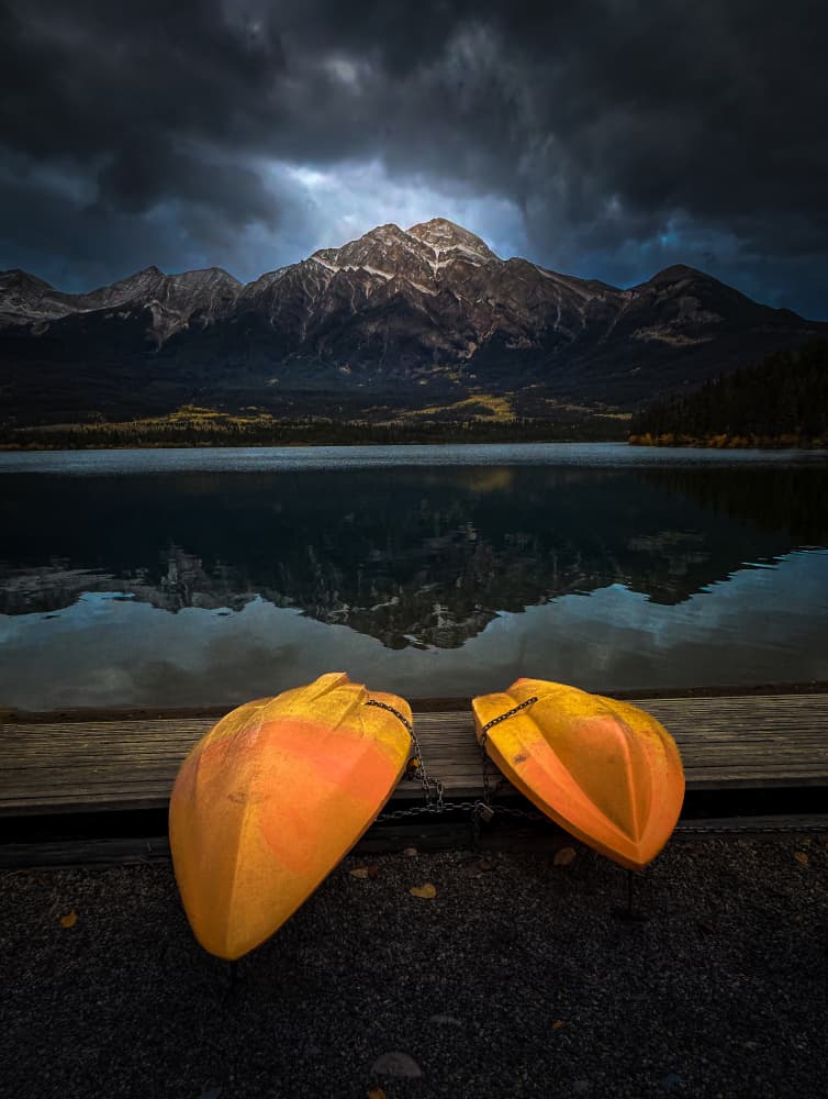 Dramatic Mountain Lake Kayaks by Bing Li — canvas wall art