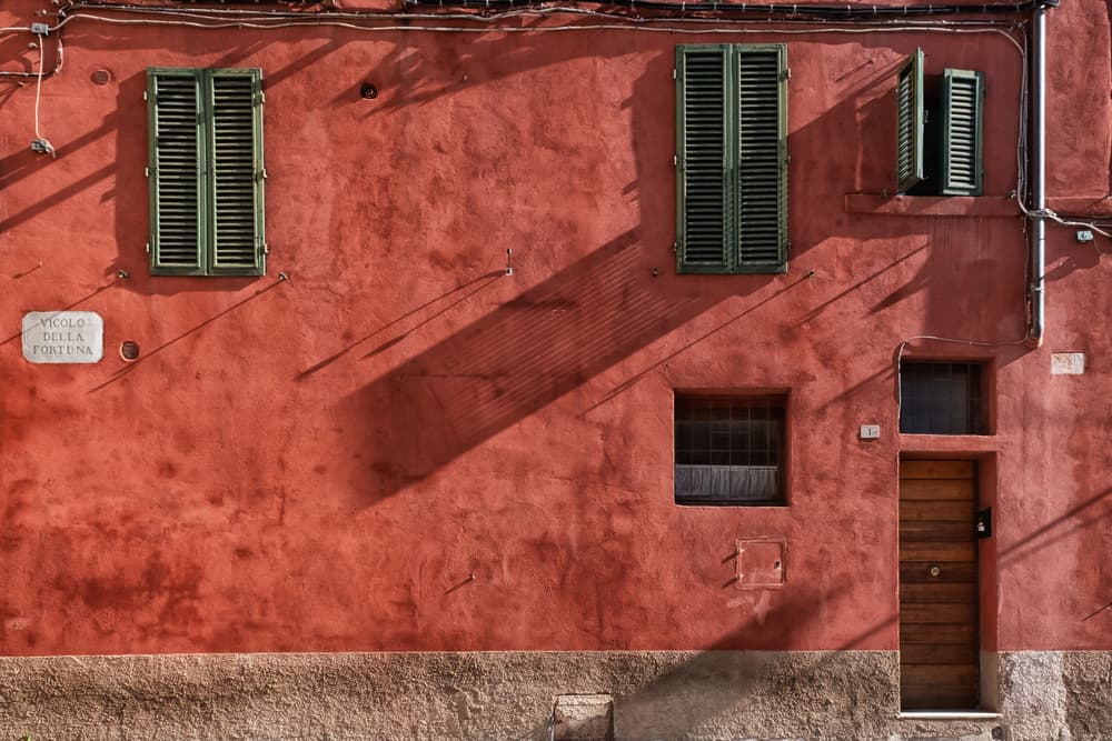 Red Wall Shadows by Luca Domenichi — canvas wall art