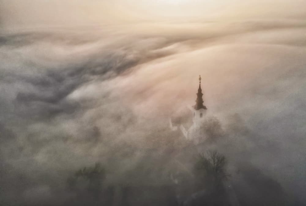Golden Foggy Church Spire by Joško Šimic — canvas wall art