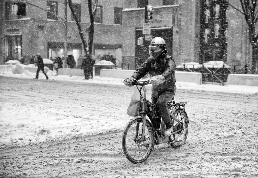 Snowy City Bike Ride by C.S. Tjandra — canvas wall art