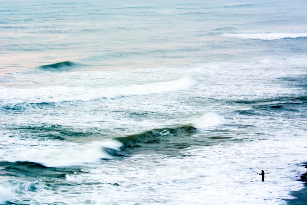 Lone Fisherman Ocean Waves by Tal Paz-Fridman — canvas wall art