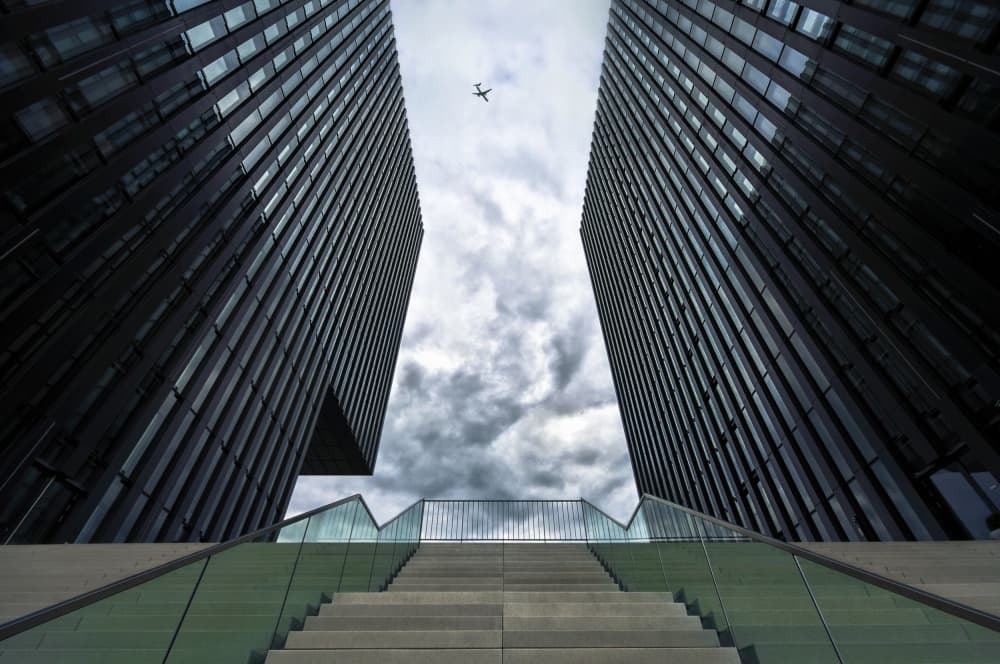 Skyscrapers Above Cloudy Sky by Ercan Sahin — canvas wall art