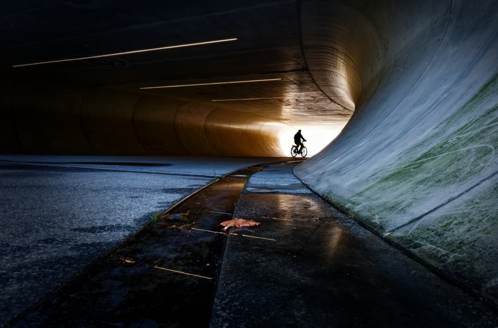 Cyclist In Tunnel Light by Andreas Timar — canvas wall art