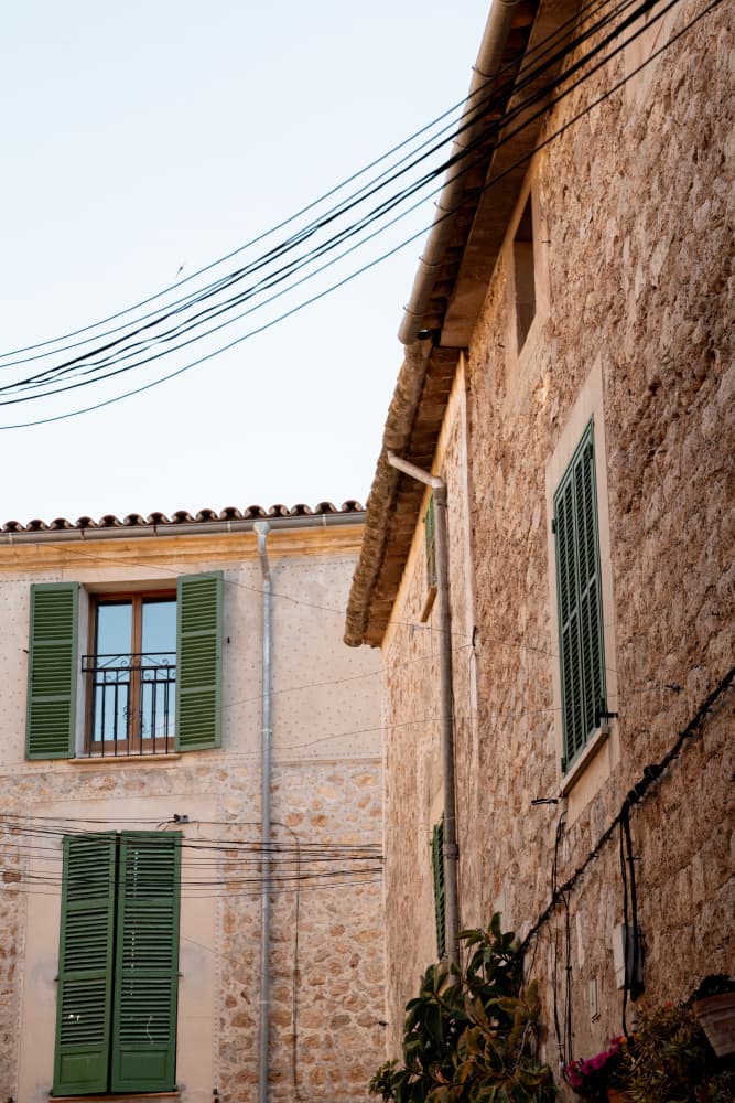 Stone Buildings Green Shutters by Henrike Schenk — canvas wall art