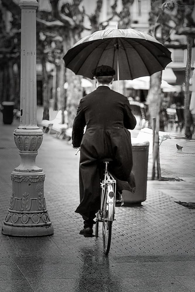 Man Cycling in Rain by Jesus Concepcion Alvarado — canvas wall art