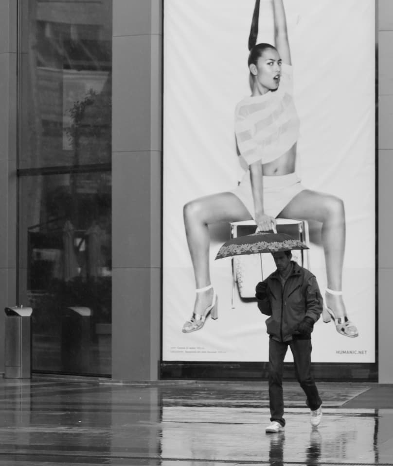 Man and Giant Ad by Tudor Thomas — canvas wall art