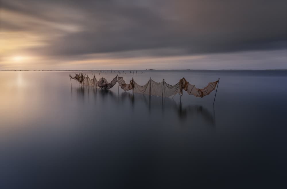 Serene Fishing Nets Sunset by Jorge Ruiz Dueso — canvas wall art