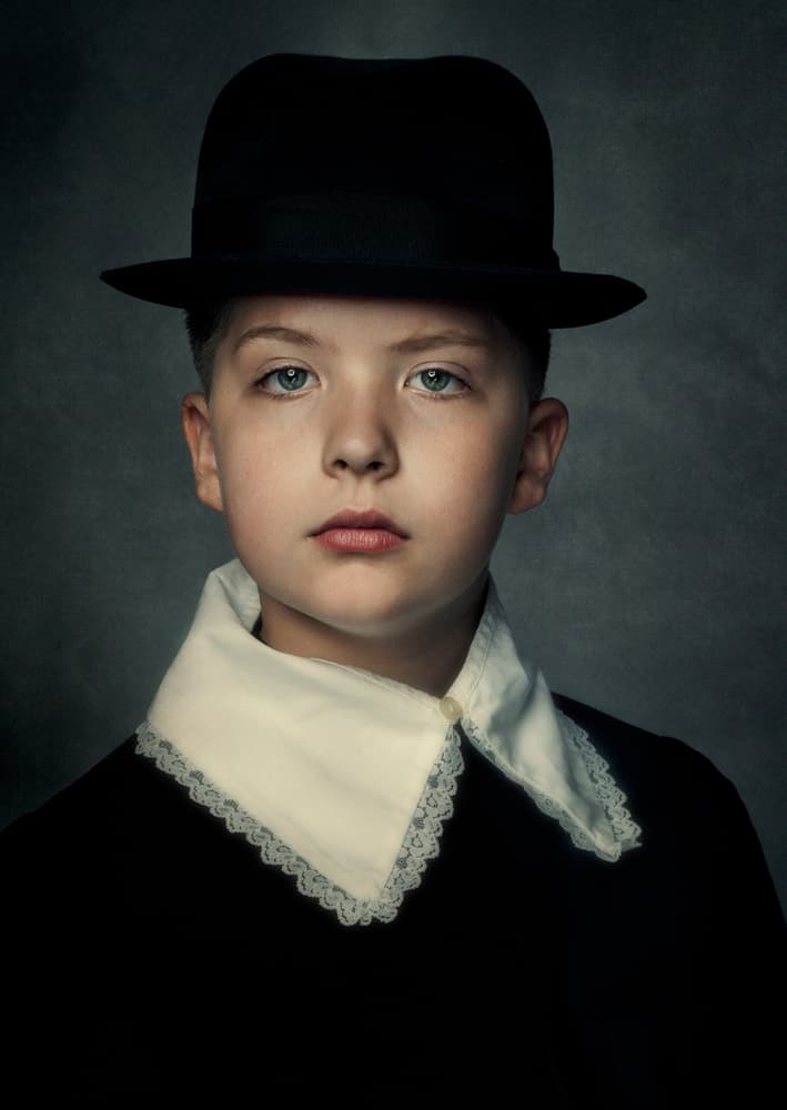 Solemn Boy with Hat by Monika Vanhercke — canvas wall art