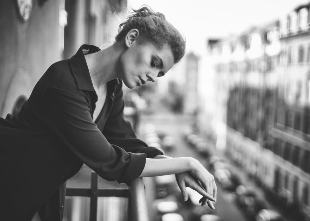 Pensive Woman City Balcony by Lukas Kaminski — canvas wall art