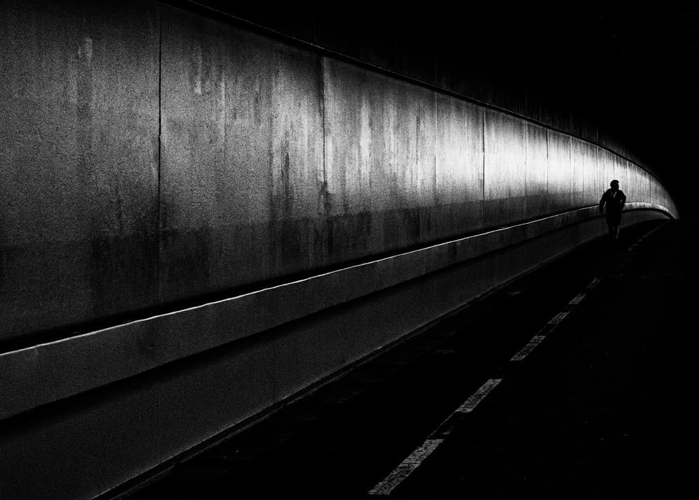 Lone Figure Dark Tunnel by Carlos Costa — canvas wall art
