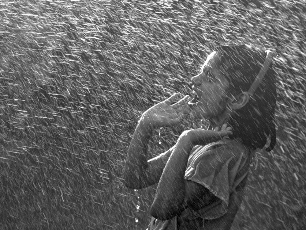 Joyful Child in Rain by Sayyed Nayyer Reza — canvas wall art