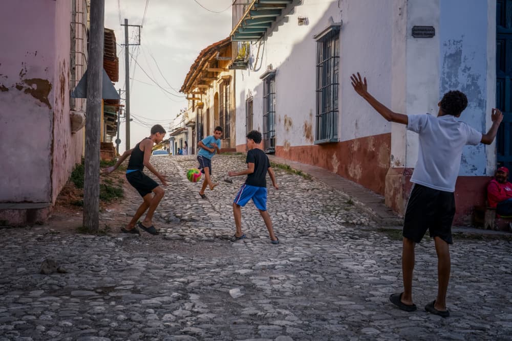 Lively Street Soccer Game by Hanping Xiao — canvas wall art