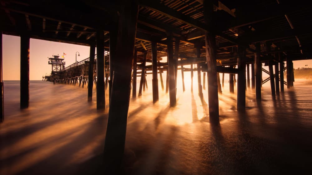 Golden Light Under Pier by Miary Andria — canvas wall art