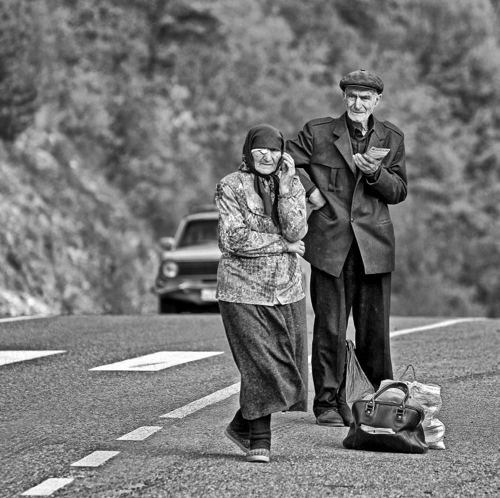 Elderly Couple Roadside by Eyal Bussiba — canvas wall art