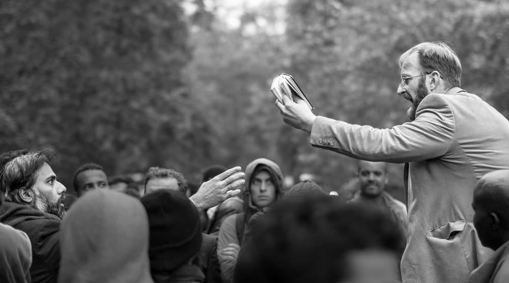 Man Addresses Crowd by Tudor Thomas — canvas wall art
