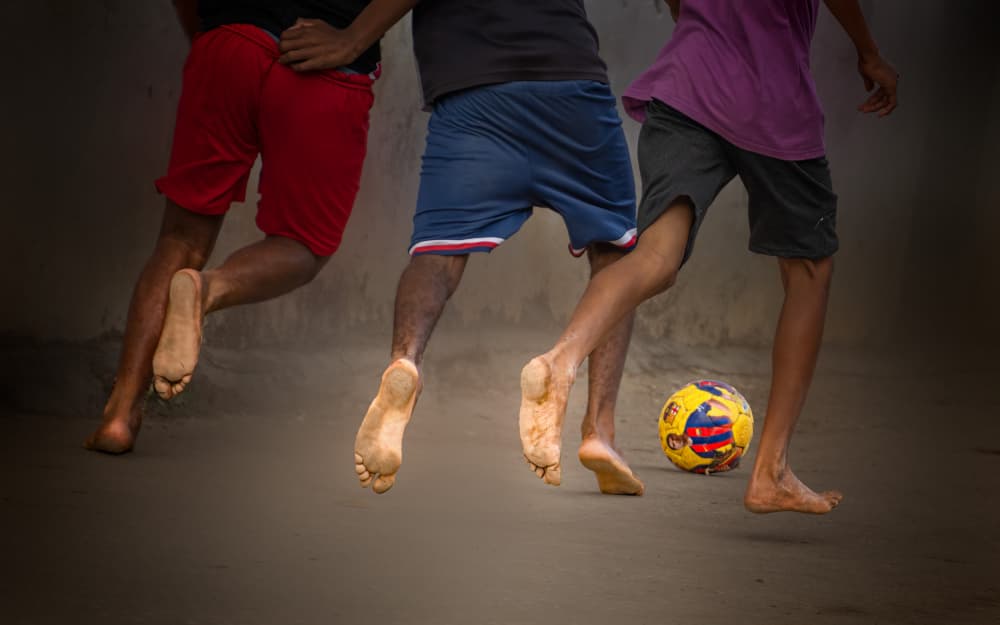 Barefoot Soccer Action by Yuan Su — canvas wall art