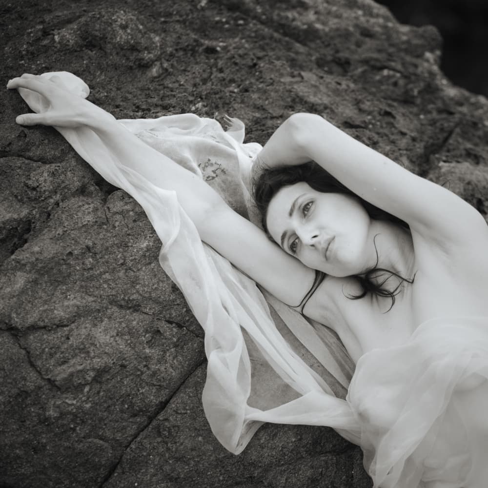 Serene Woman on Rocks by Mel Brackstone — canvas wall art