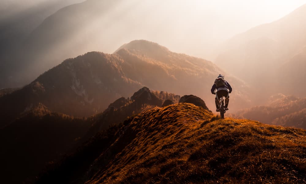Biker on Mountain Ridge by Sandi Bertoncelj — canvas wall art