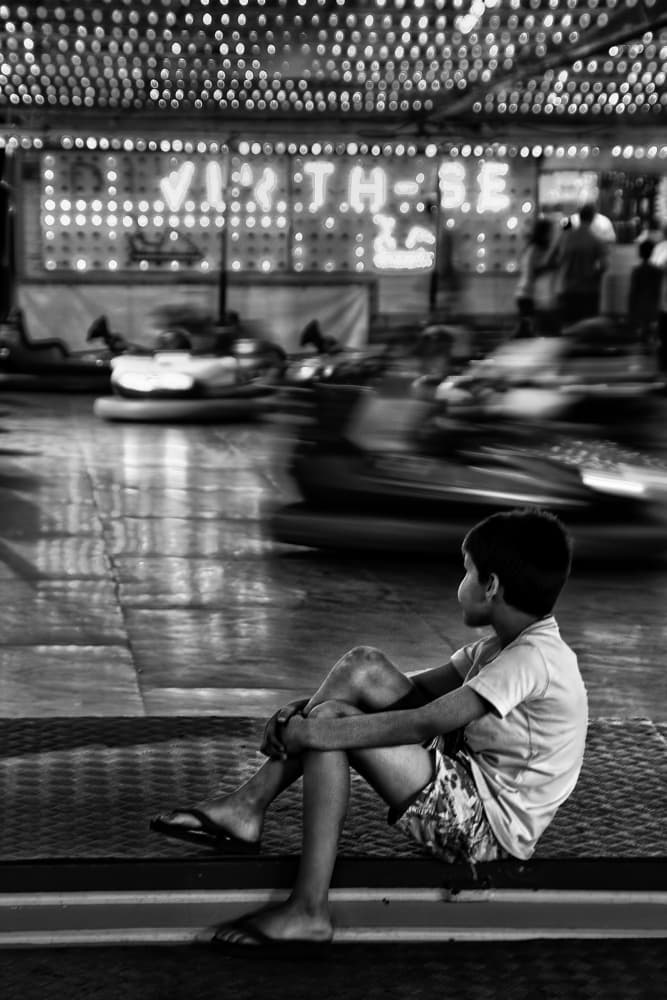 Boy Watching Carnival Ride by Fernando Alves — canvas wall art