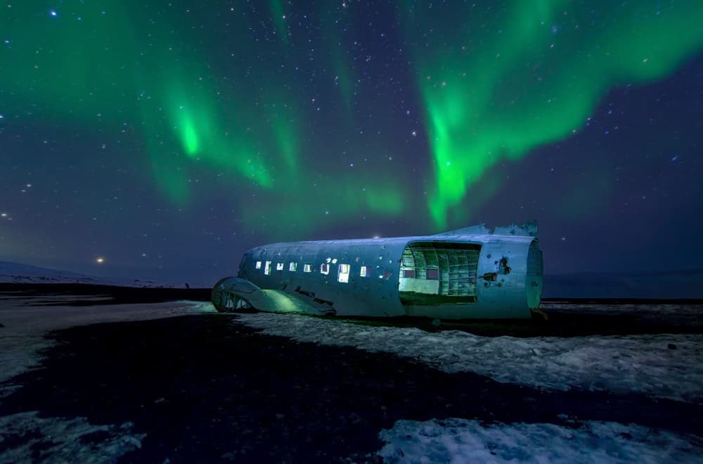 Icelandic Aurora Plane Wreck by Andrea Auf dem Brinke — canvas wall art