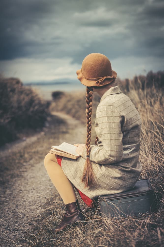Girl Reading On Suitcase by Magdalena Russocka — canvas wall art