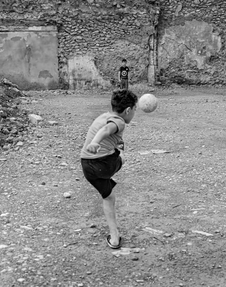 Boys Play Street Soccer by Bashar Alsofey — canvas wall art